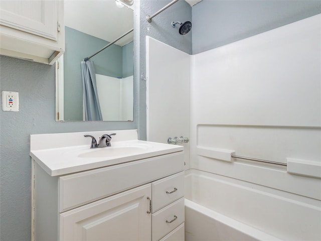 full bathroom featuring shower / bath combo with shower curtain and vanity