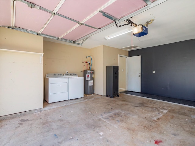 garage with a garage door opener, washing machine and dryer, and electric water heater