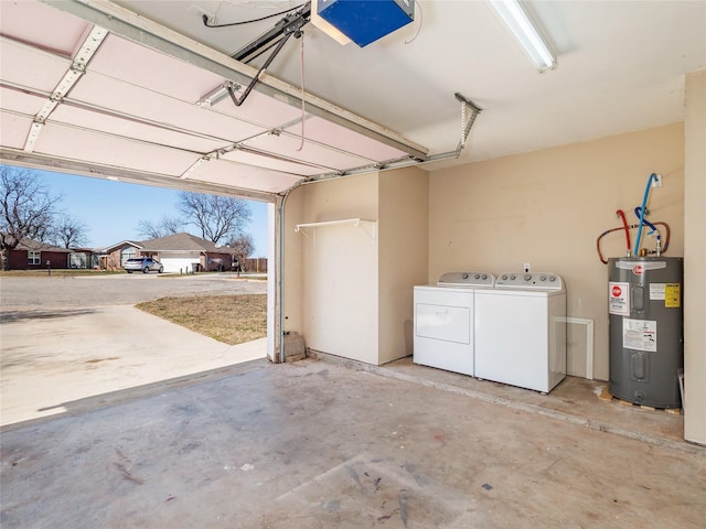 garage featuring a garage door opener, washing machine and dryer, and water heater