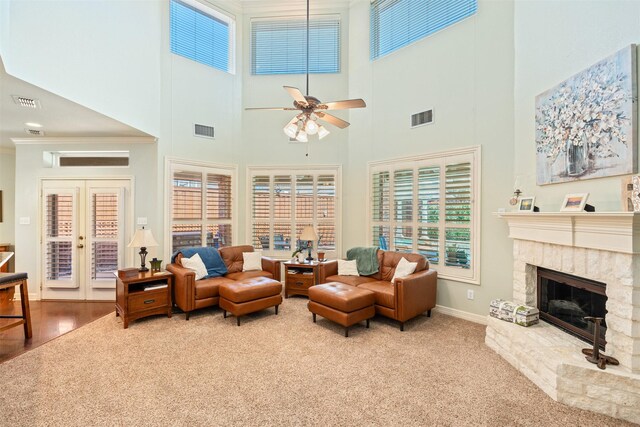 living area with a fireplace, visible vents, and baseboards