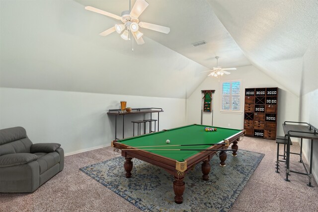 rec room with visible vents, a textured ceiling, carpet flooring, and vaulted ceiling