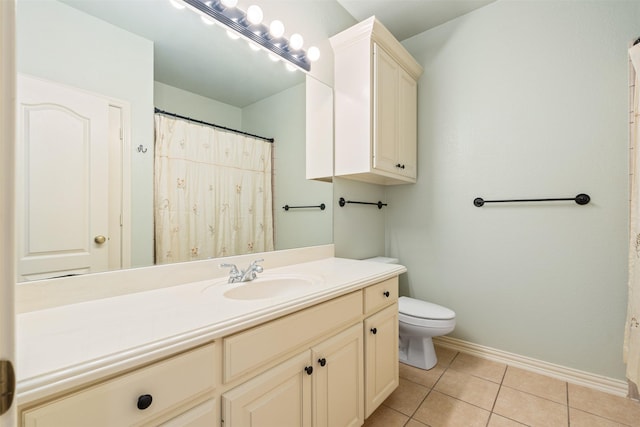 full bath featuring baseboards, toilet, vanity, and tile patterned flooring