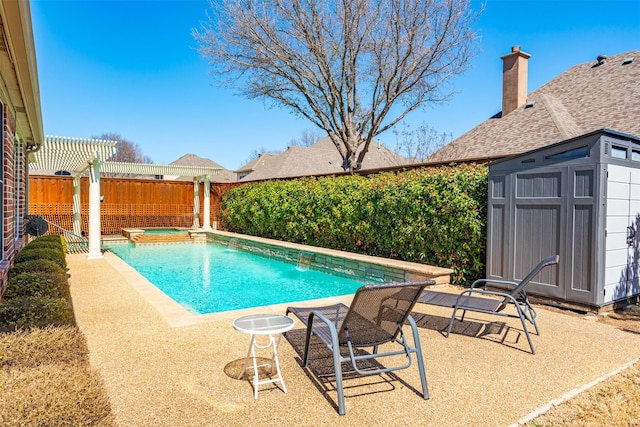 view of pool featuring an outbuilding, a patio, a fenced in pool, an in ground hot tub, and a fenced backyard