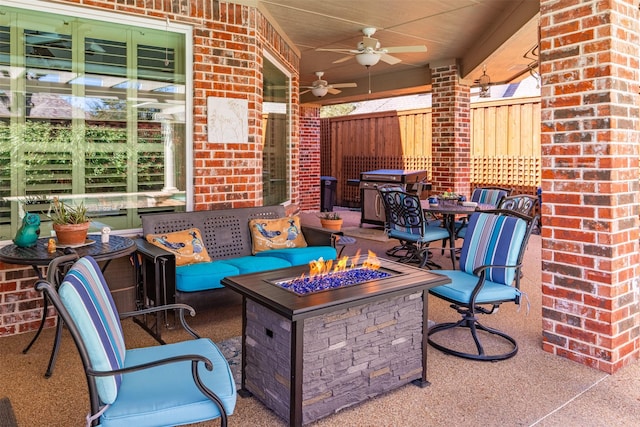 view of patio / terrace with area for grilling, an outdoor living space with a fire pit, a ceiling fan, and fence