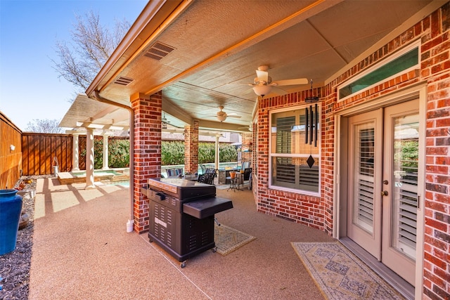 view of patio / terrace featuring a ceiling fan and fence