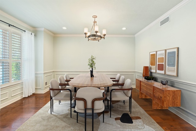 dining space featuring visible vents, an inviting chandelier, wood finished floors, and ornamental molding