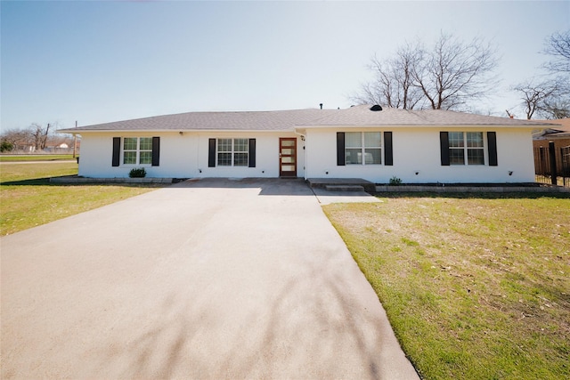 ranch-style house with driveway and a front yard