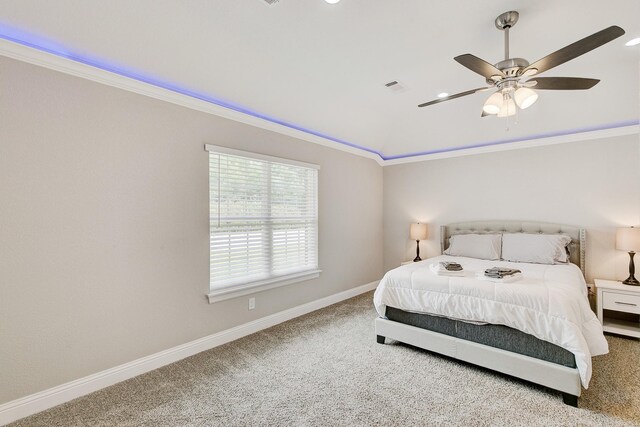 bedroom with baseboards, visible vents, lofted ceiling, crown molding, and carpet flooring