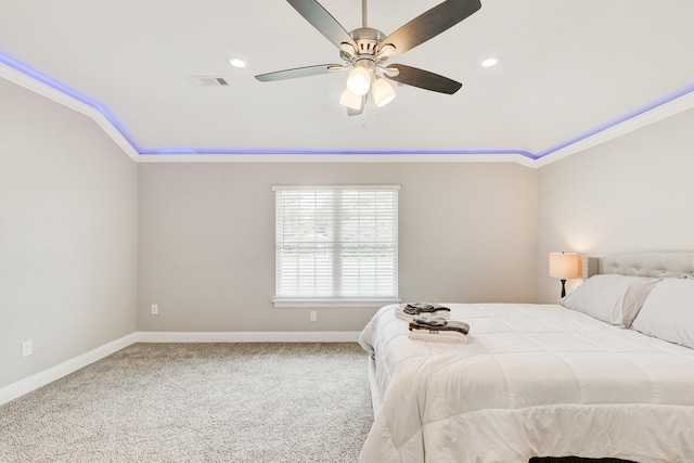 carpeted bedroom featuring visible vents, a ceiling fan, baseboards, and ornamental molding