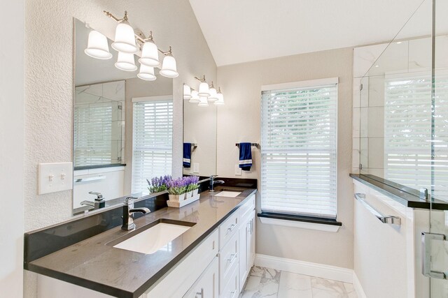 bathroom with a shower stall, marble finish floor, and a sink