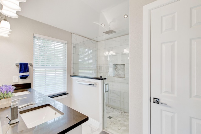 bathroom with marble finish floor, a stall shower, and vanity