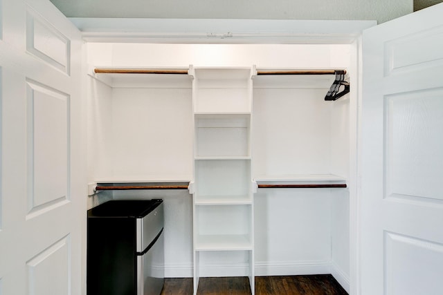 walk in closet featuring dark wood-style floors