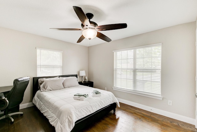 bedroom with baseboards, wood finished floors, and a ceiling fan