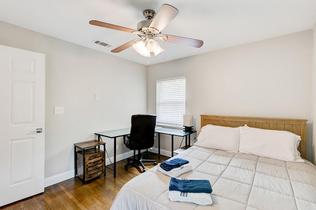 bedroom with visible vents, ceiling fan, baseboards, and wood finished floors