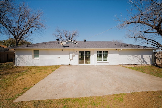 rear view of property featuring a yard, a patio, brick siding, and fence