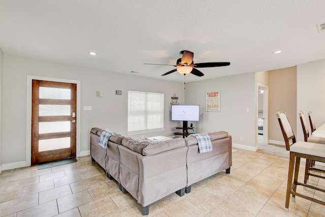 living area with a ceiling fan, recessed lighting, visible vents, and baseboards