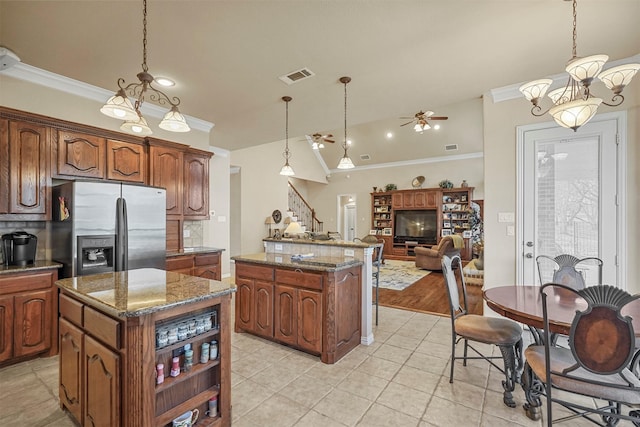 kitchen with visible vents, a center island, ornamental molding, and stainless steel refrigerator with ice dispenser