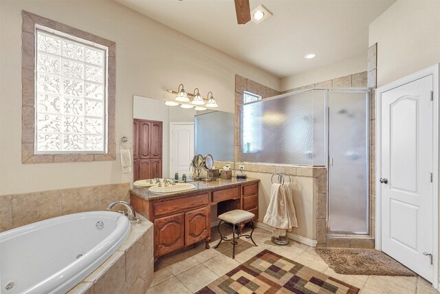 bathroom with tile patterned floors, a tub with jets, a shower stall, and vanity