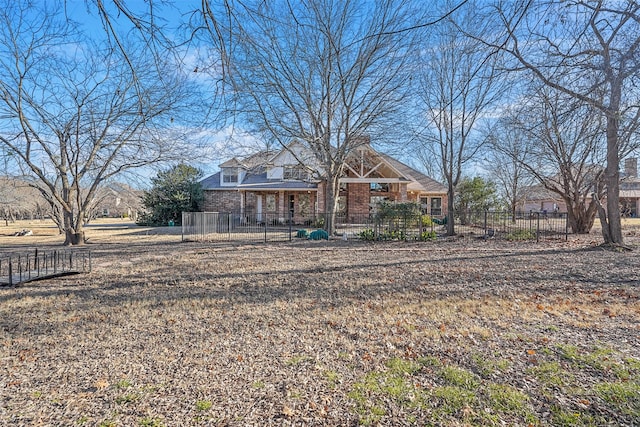 exterior space featuring a fenced front yard and brick siding