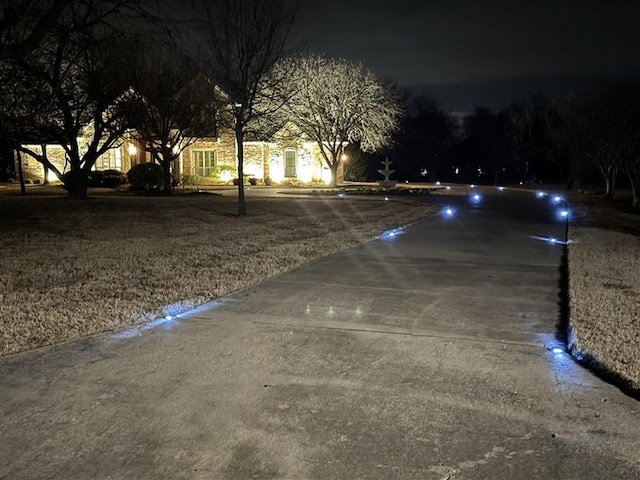 view of street featuring concrete driveway