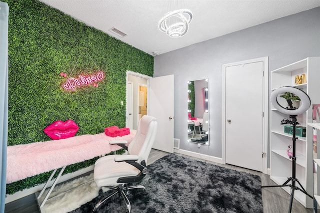 office space featuring visible vents, baseboards, and wood finished floors