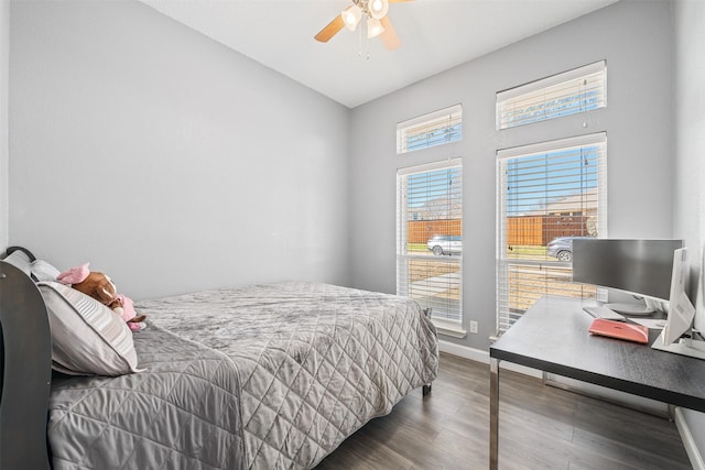 bedroom featuring a ceiling fan, wood finished floors, and baseboards