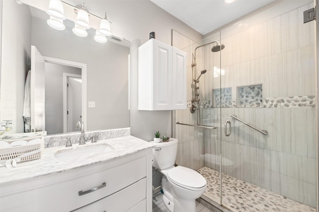 full bathroom with visible vents, toilet, a stall shower, and vanity