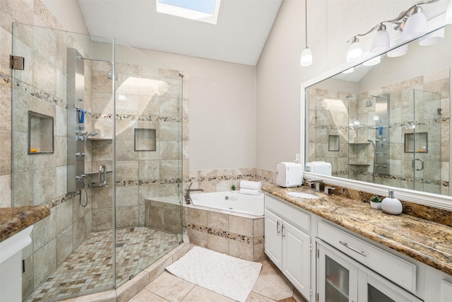 bathroom with a bath, vaulted ceiling with skylight, a stall shower, and vanity