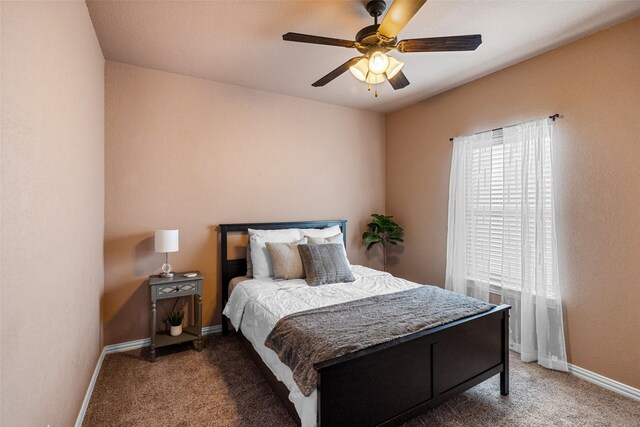 bedroom featuring ceiling fan, baseboards, and carpet floors