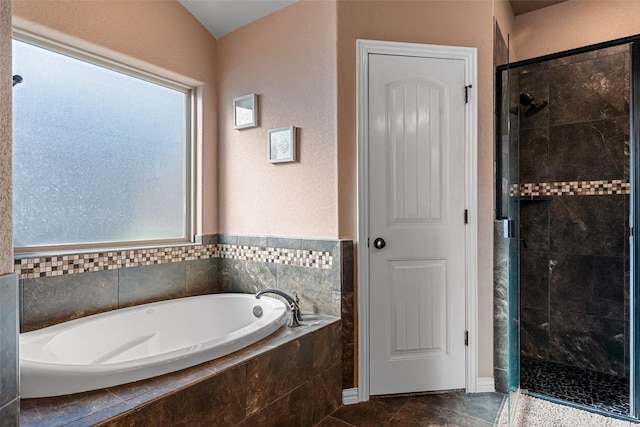 full bathroom featuring a garden tub and a stall shower