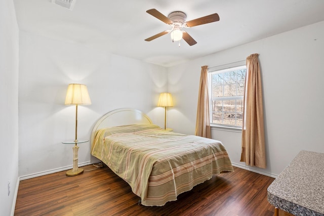 bedroom featuring ceiling fan, wood finished floors, visible vents, and baseboards