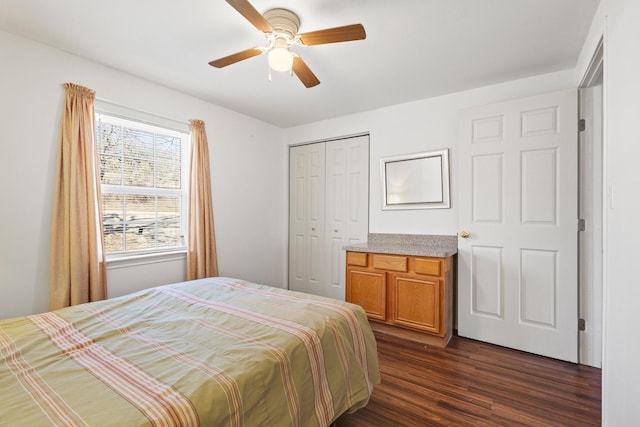 bedroom with dark wood-type flooring, a closet, and ceiling fan