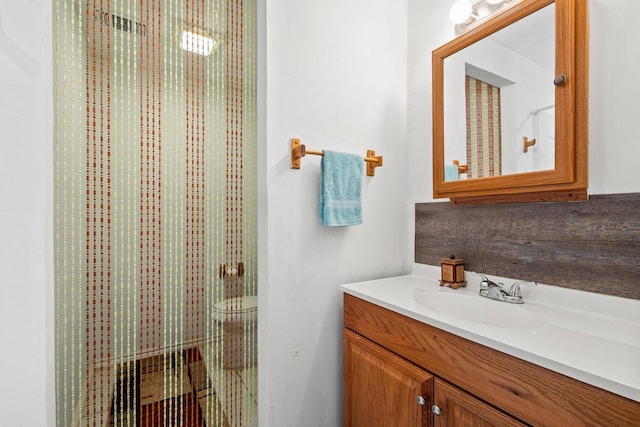 bathroom with toilet and vanity