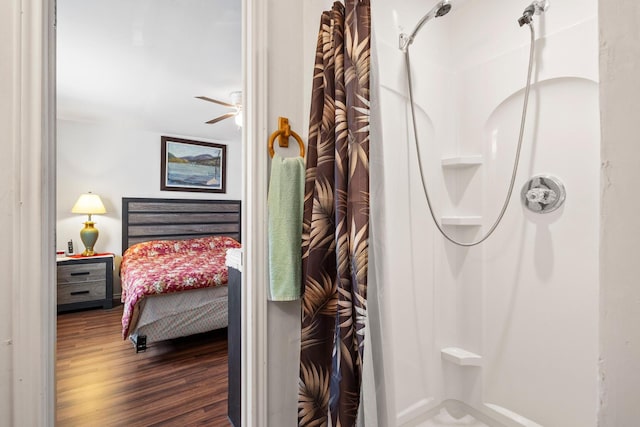 bathroom with a shower with curtain and wood finished floors