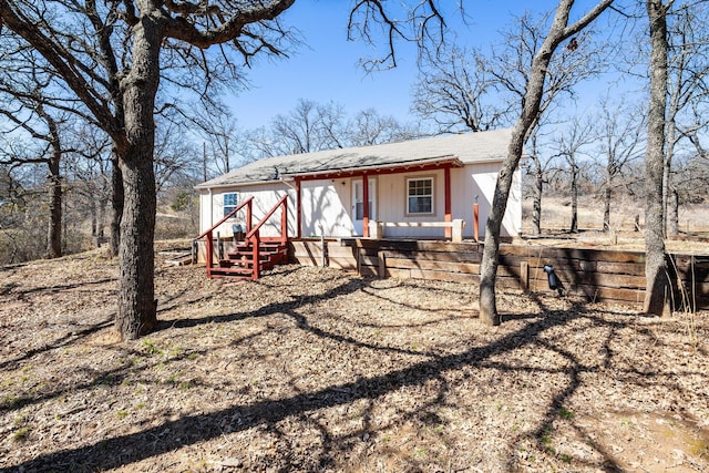 rear view of property featuring a porch