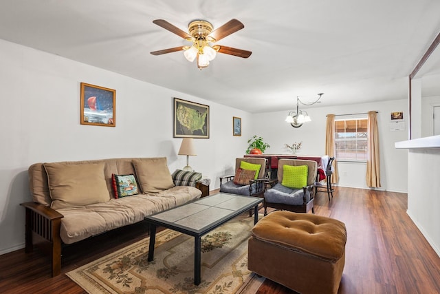 living room featuring ceiling fan with notable chandelier and wood finished floors