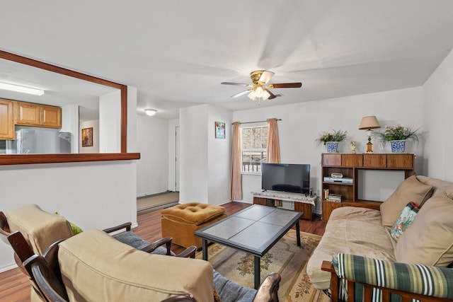 living room featuring a ceiling fan and wood finished floors