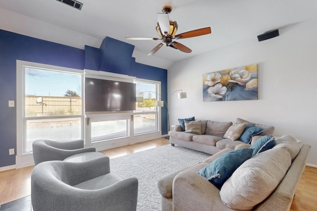 living room with visible vents, ceiling fan, lofted ceiling, and wood finished floors