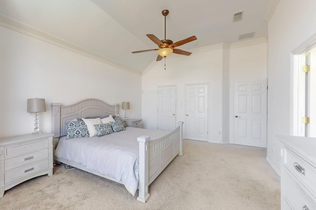 bedroom with visible vents, light carpet, and crown molding