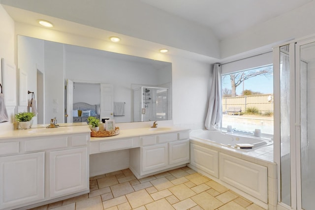 ensuite bathroom with vanity, ensuite bath, recessed lighting, a shower stall, and a garden tub