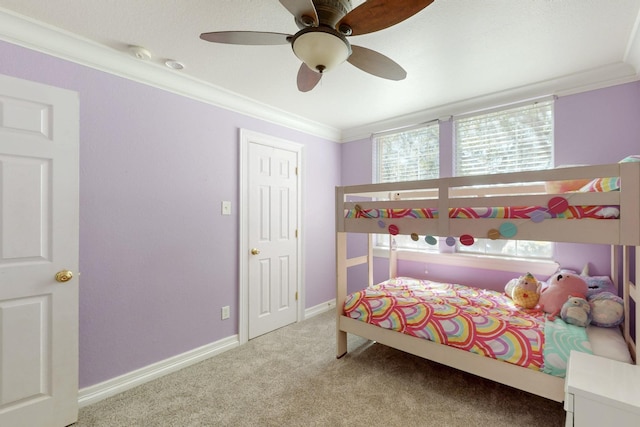 bedroom with carpet floors, ceiling fan, baseboards, and ornamental molding