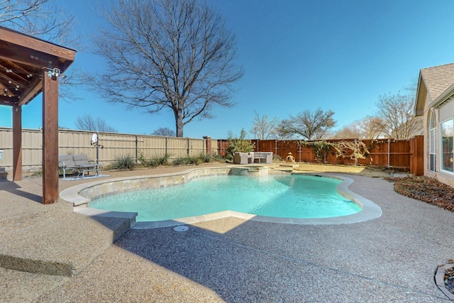 view of pool with a patio, a fenced backyard, and a pool with connected hot tub