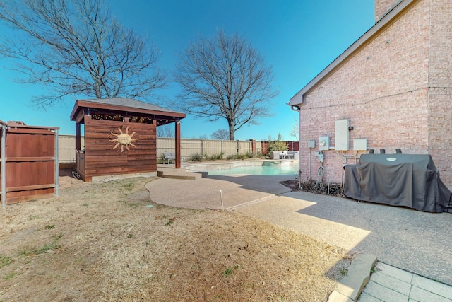 view of yard with a fenced in pool, a fenced backyard, and a patio area