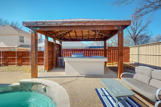 view of patio / terrace featuring a gazebo, area for grilling, a grill, and a fenced backyard