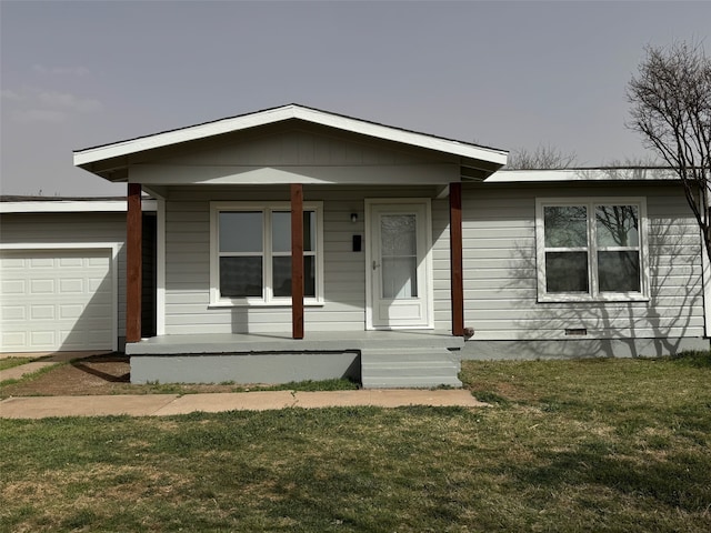 view of front of property with crawl space, a garage, and a front lawn