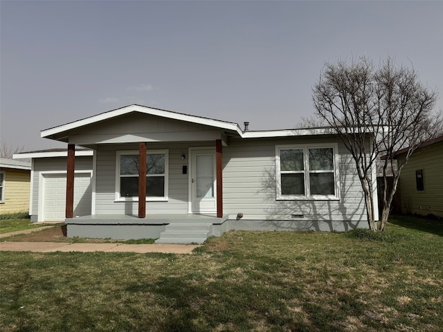 view of front of home with an attached garage and a front lawn