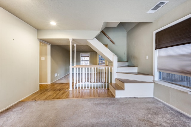 interior space featuring visible vents, baseboards, and carpet flooring