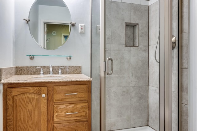 full bathroom featuring a stall shower and vanity