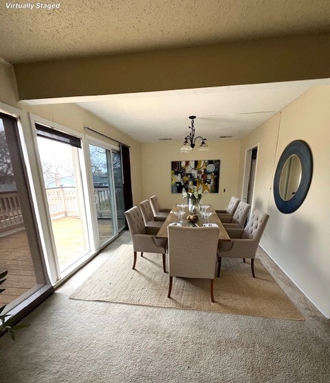 dining area featuring beamed ceiling, baseboards, light colored carpet, and a notable chandelier