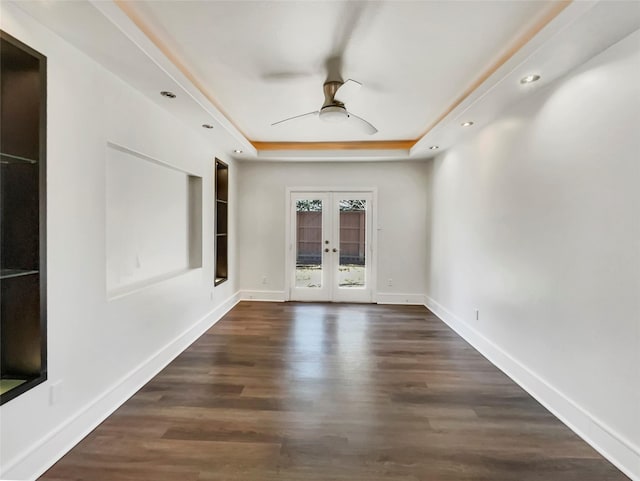 spare room with french doors, baseboards, wood finished floors, and a ceiling fan